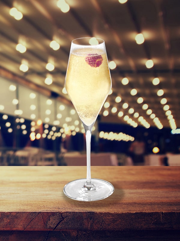 cocktail mangue royale coupe de champagne avec framboise à l'intérieur
