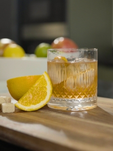 Cocktail Old Fashioned avec du whisky de seigle, du sucre, du bitter servi dans un verre à whisky avec des glaçons.