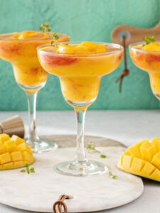 Cocktail Mango Margarita, servi en version frozen dans un verre à margarita.